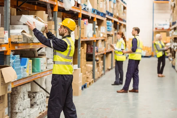 depositphotos_65562659-stock-photo-warehouse-worker-taking-package-in